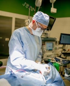 Board certified oral surgeon Dr Alan Harvey perfoming surgery